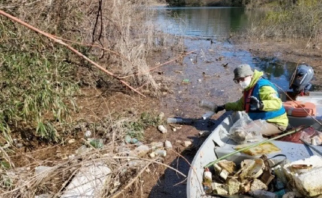 Employees cleaning up the lakeshores